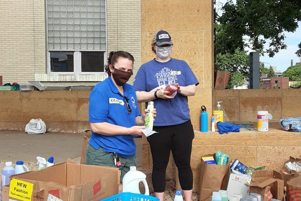 Liz (on the right) volunteering with NECHAMA at a food bank in June 2020.