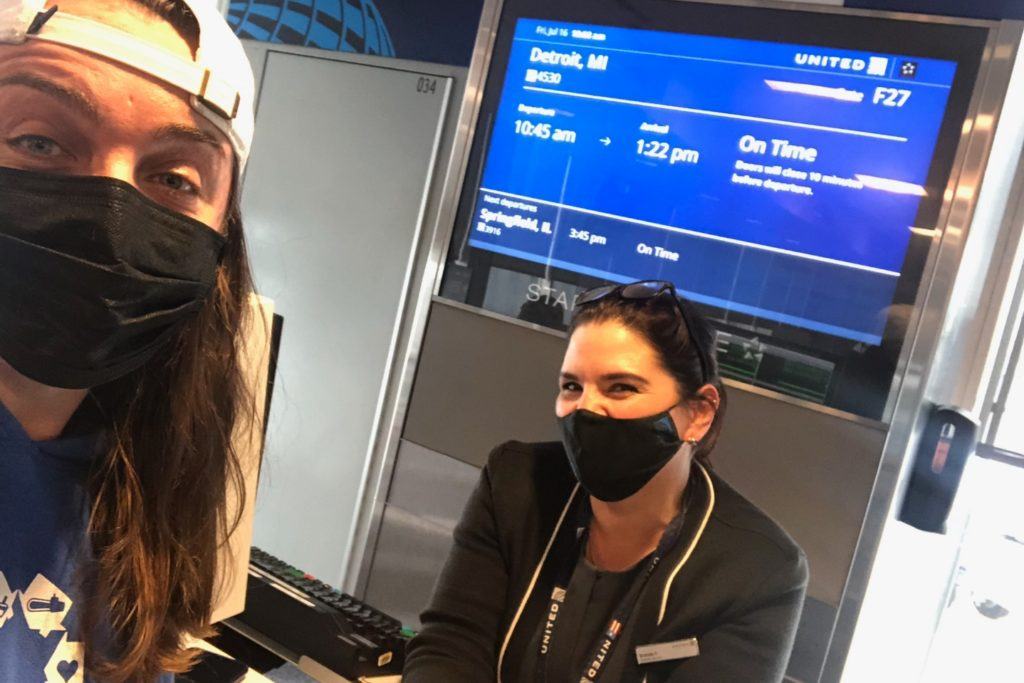 donate your frequent flyer miles! A Nechama volunteer is shown with a Delta airlines agent checking into a flight donated through Airlink