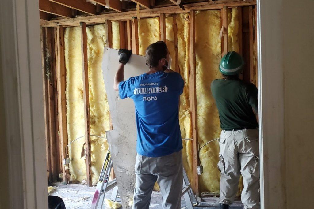 Operations Update: Hurricane Ida, Kentucky tornado, Midwest Derecho. Image: a Nechama and AmeriCorps volunteer clear walls inside a home of damage caused by Hurricane Ida.