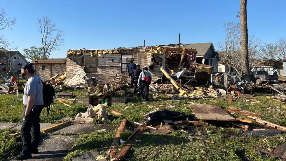 Search and rescue crews check a damaged home in St. Bernard Parish, Louisiana, on Wednesday, March 23, 2022
