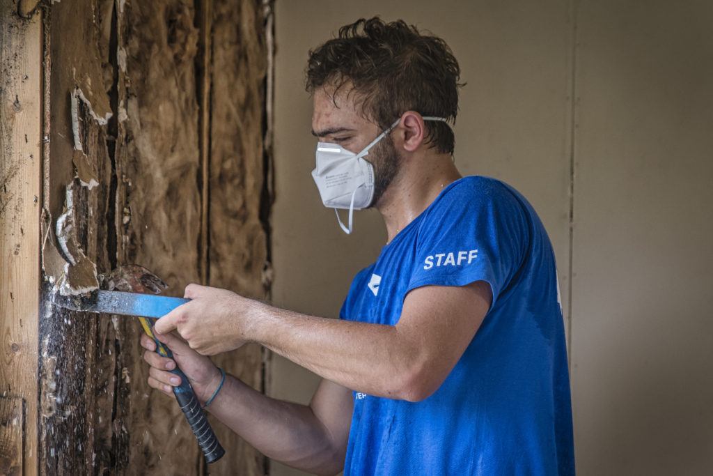 Response Extended- a NECHAMA staff member works to pull moldy drywall from a home damaged during Hurricane Ida in 2021