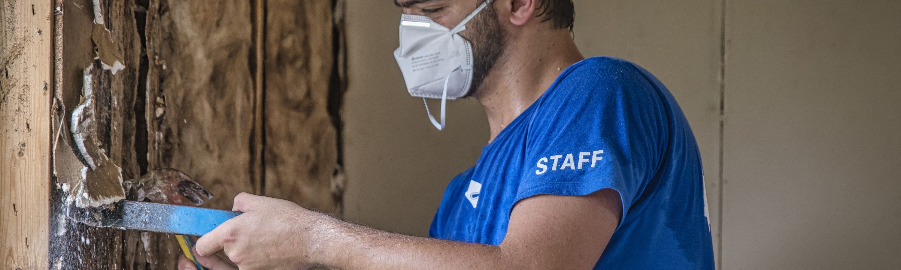 Response Extended- a NECHAMA staff member works to pull moldy drywall from a home damaged during Hurricane Ida in 2021